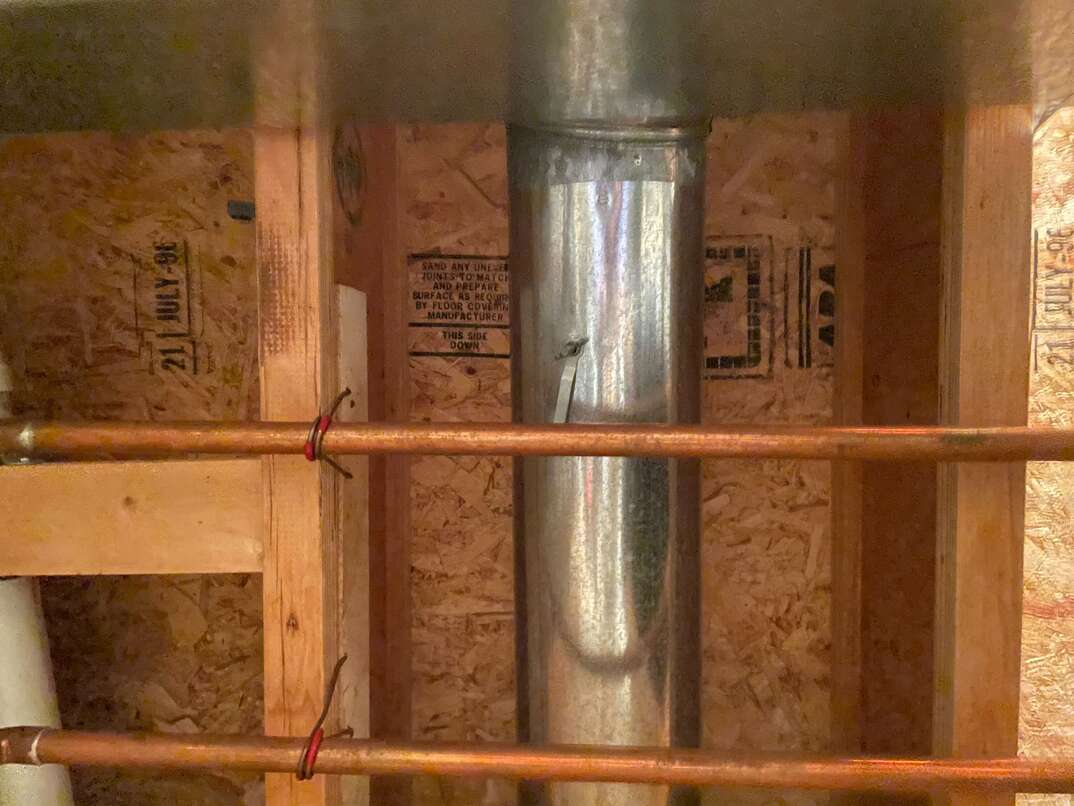 Exposed pipes and ductwork in the ceiling
