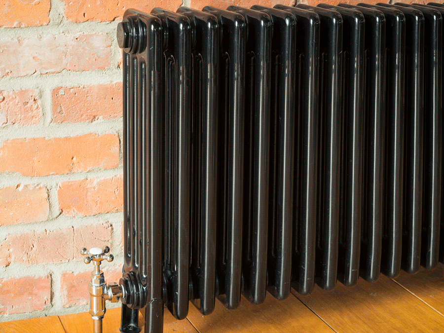 animated gif showing a visual  banging  of an old fashioned   retro radiator against a brick wall 