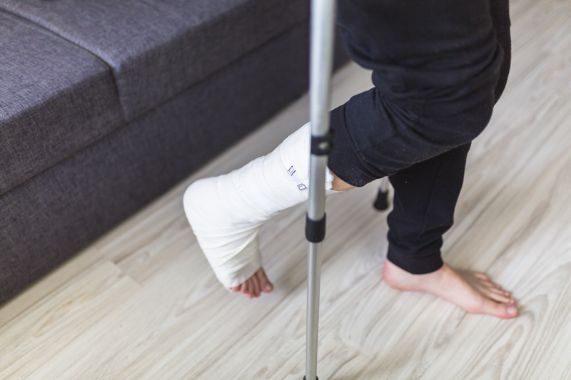walking on crutches with a leg in a cast