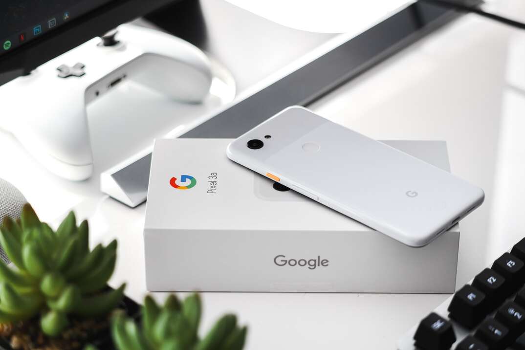 A white Google Pixel smartphone sits atop its packaging bearing the Google G logo