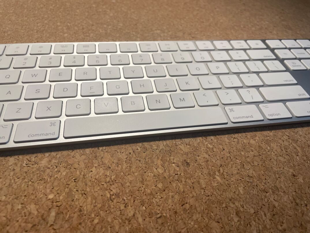 Apple brand wireless keyboard on a desk