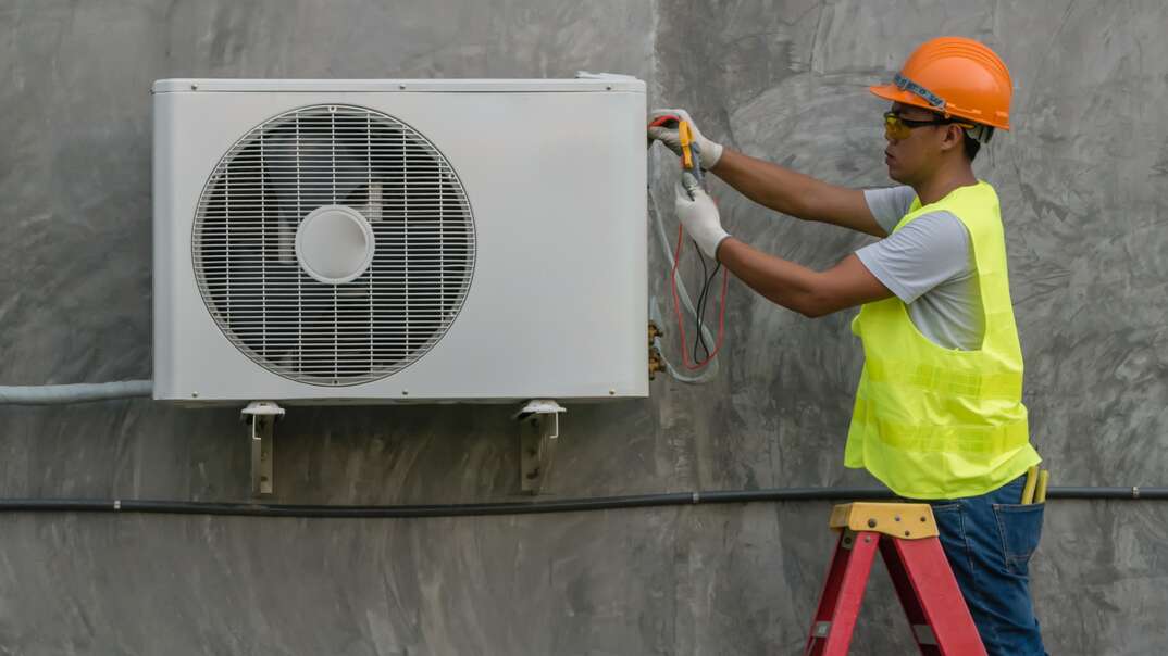 Technician is checking outdoor air conditioner unit