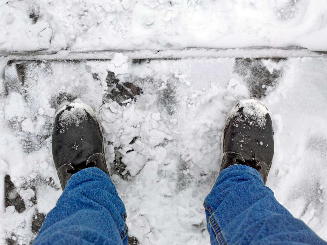 Man s boots on frozen concrete steps