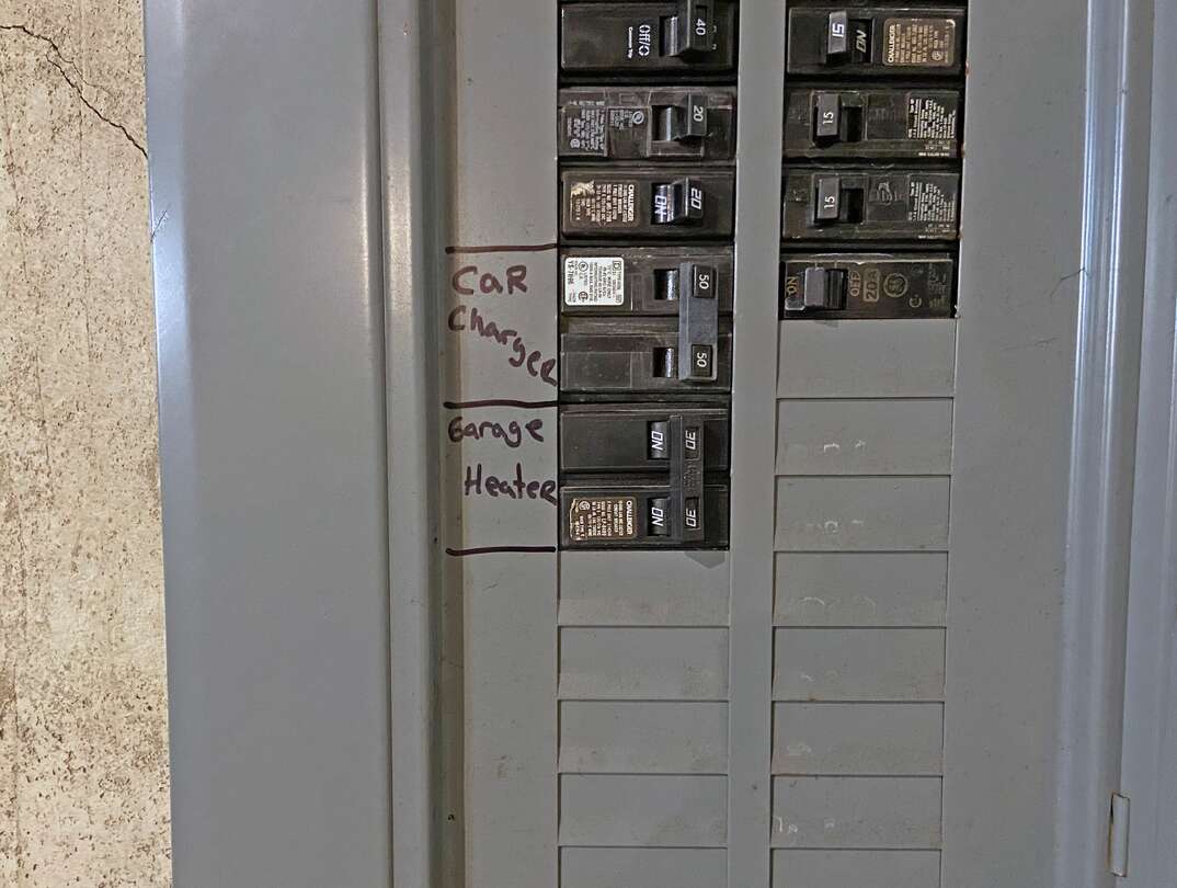 close-up of an electrical service panel showing a 50amp circuit breaker labeled  car charger  