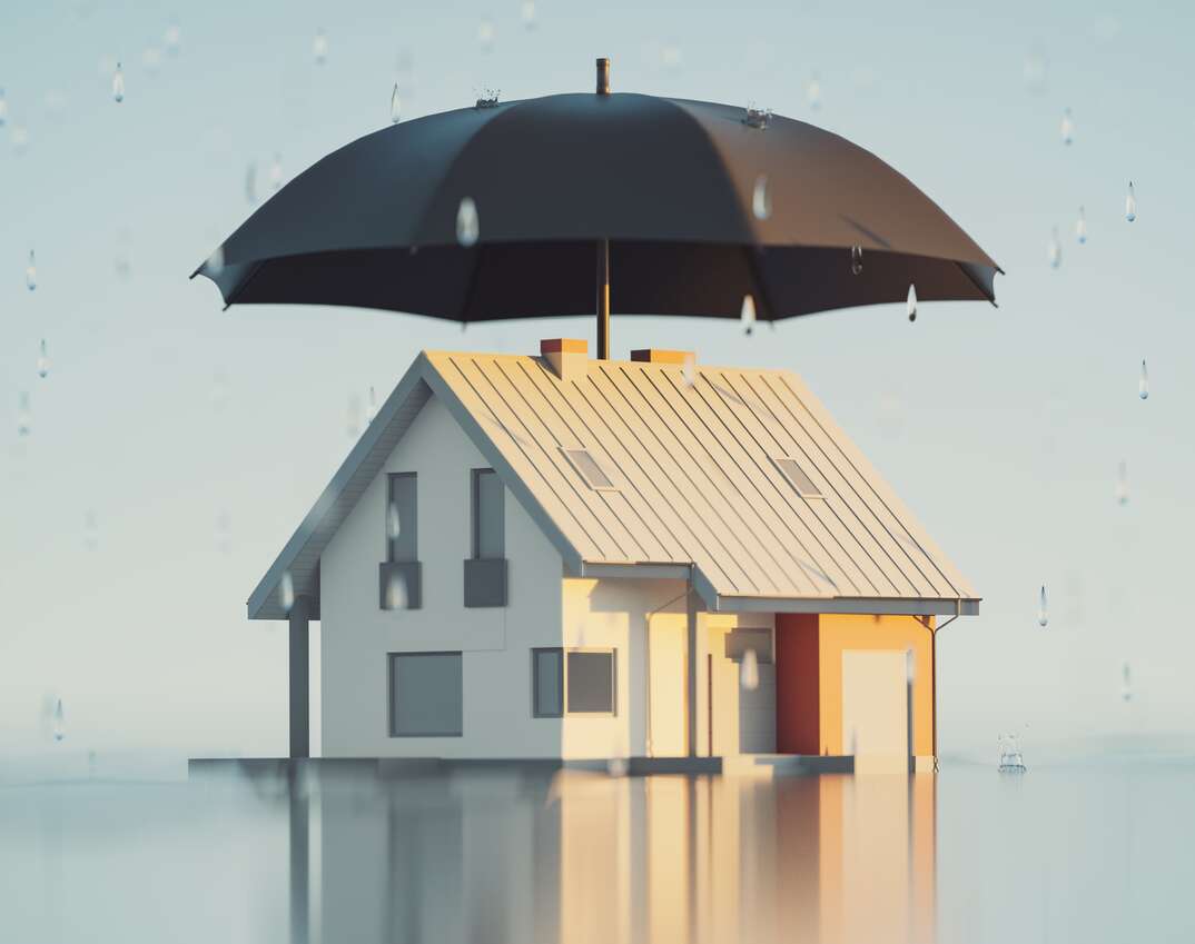 a 3D render of a House covered by a large umbrella to represent insurance