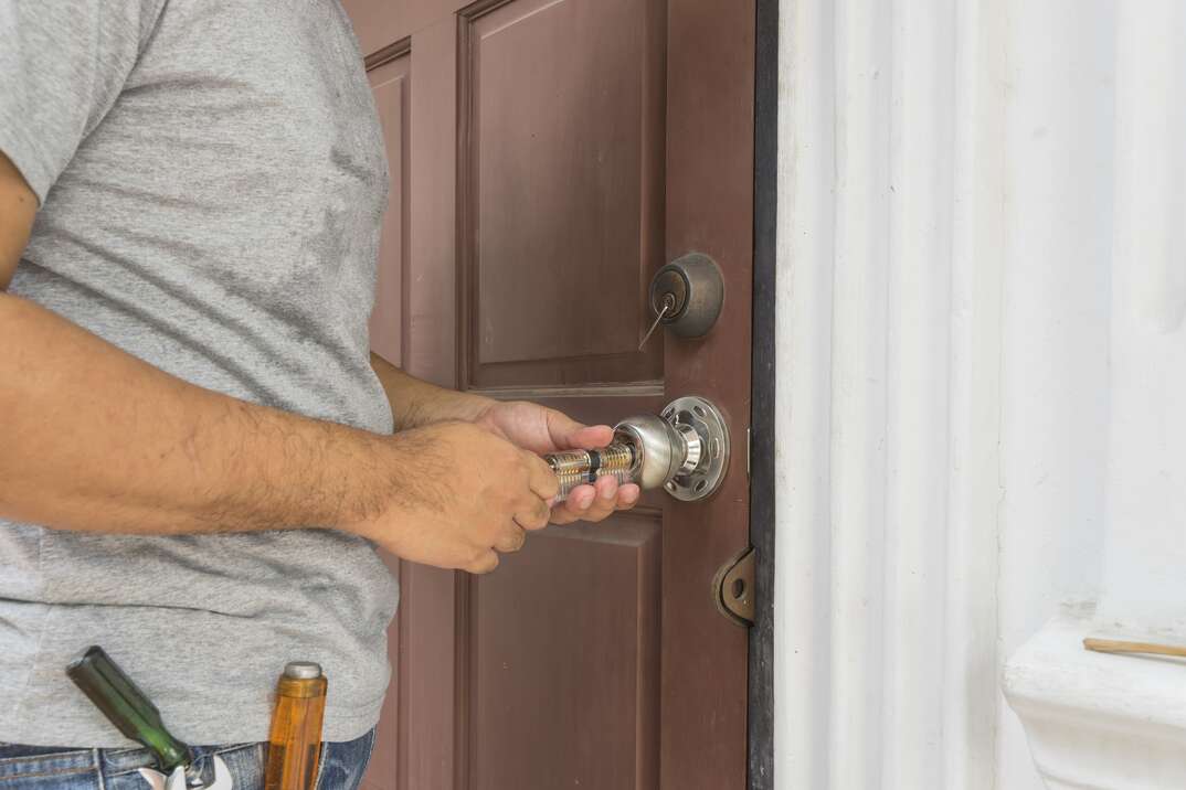 locksmith try to open old wood door with his tools - can use to display or montage on products