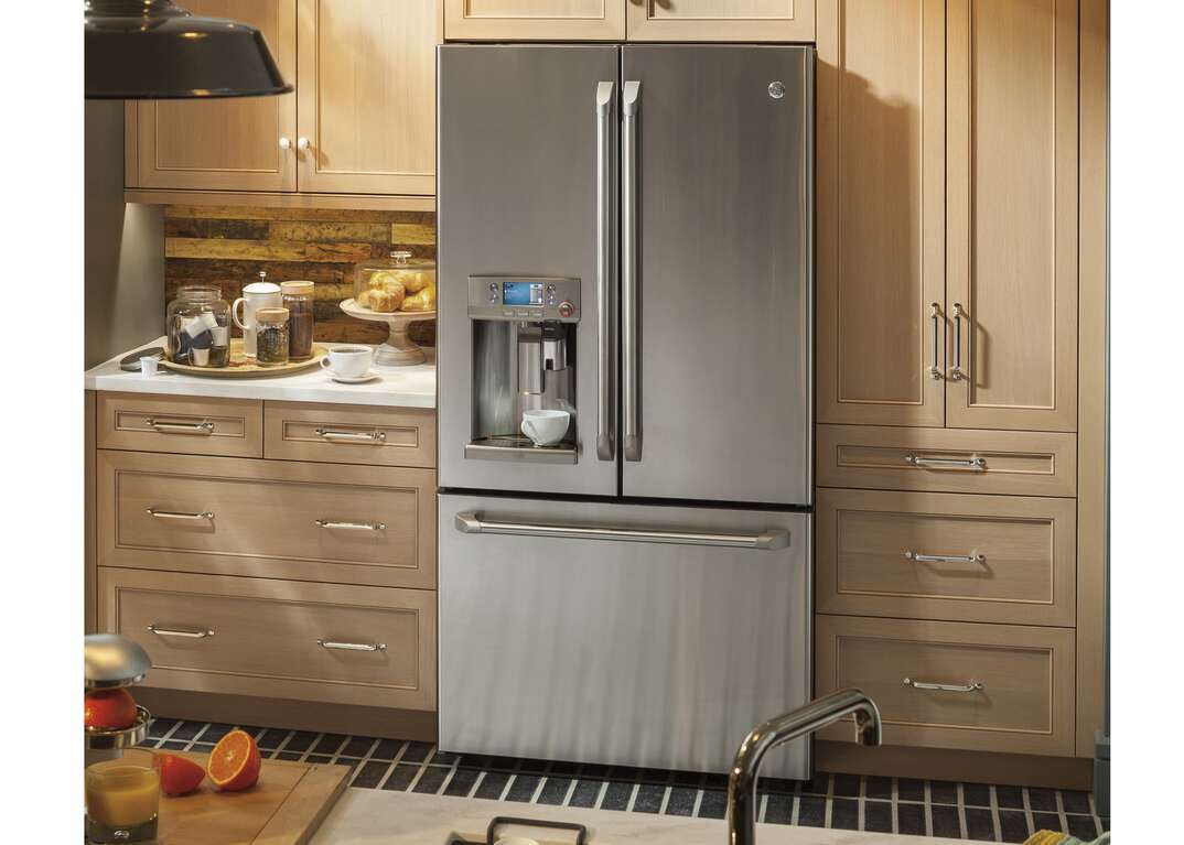 A stainless steel French door refrigerator stands in an upscale domestic kitchen