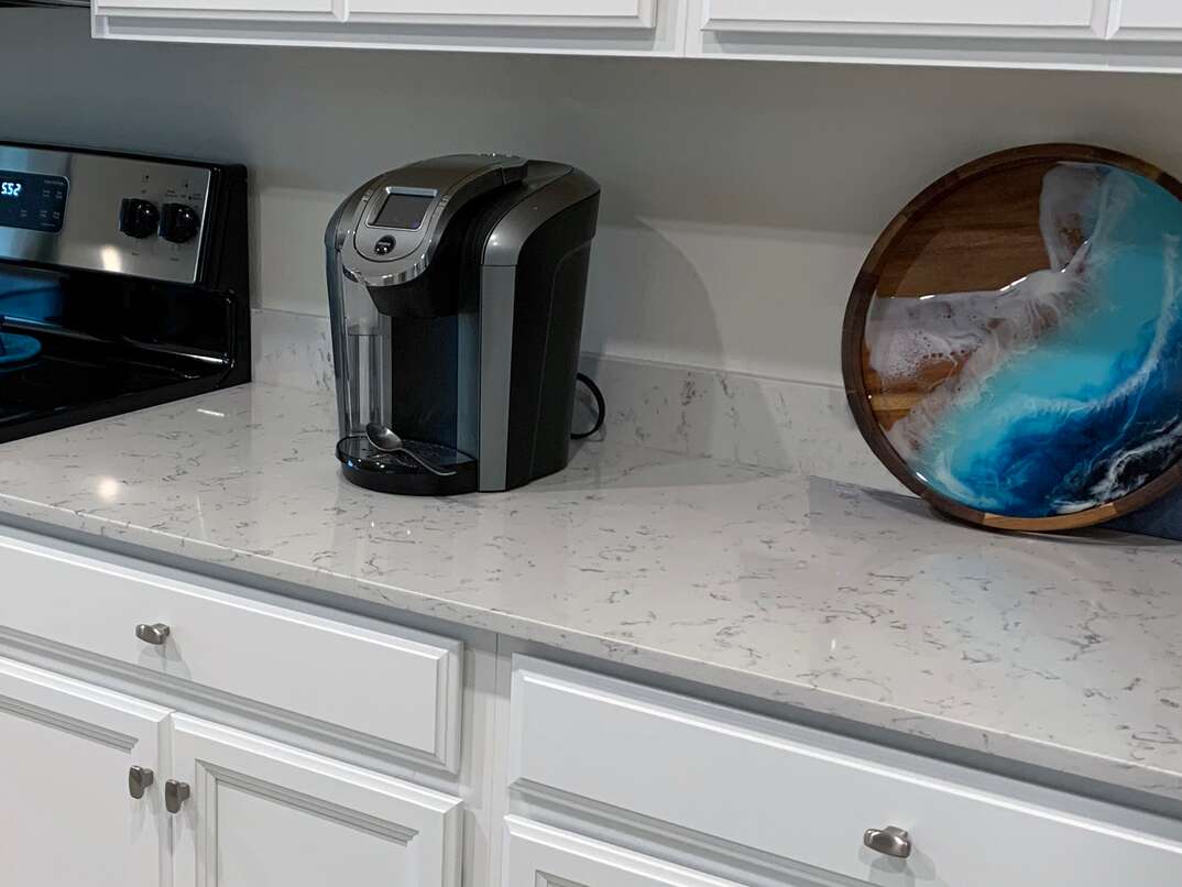 close up shot of white man-made quartz counter tops in a residential kitchen 