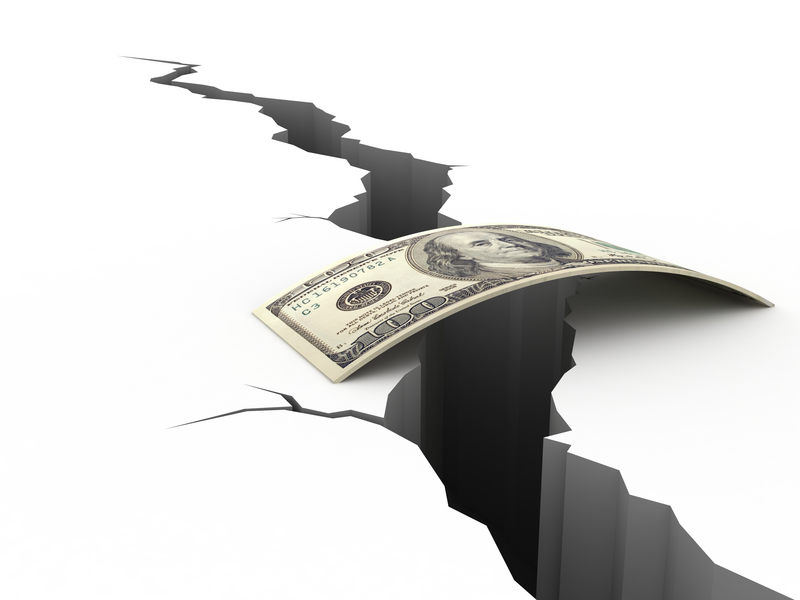 A graphic illustration shows a stack of hundred dollar bills spanning a huge crack in the ground against an all white background, gap insurance, insurance, coverage, insurance coverage, gap, crack, crevice, fissure, canyon, hundred dollar bills, $100 bills, money, cash, bills