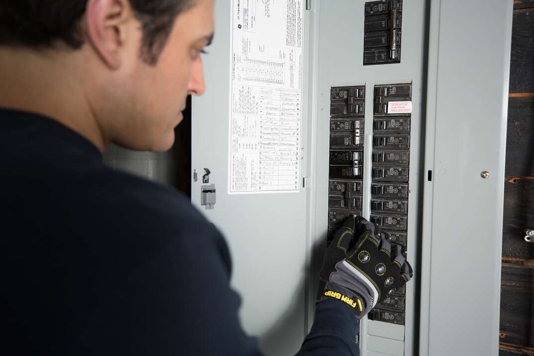 technician checking fuse box