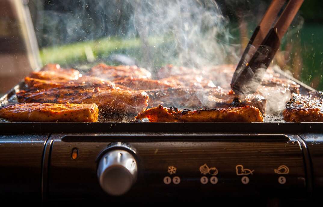 Tasty chicken steaks on the contact electric grill