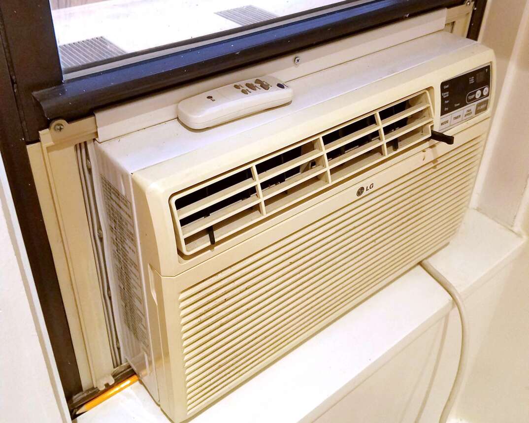 A window unit air conditioner is positioned in a window.