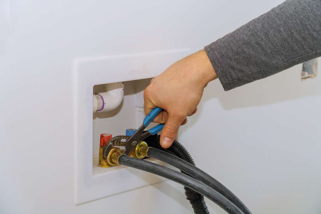connecting water supply hose to washing machine using wrench