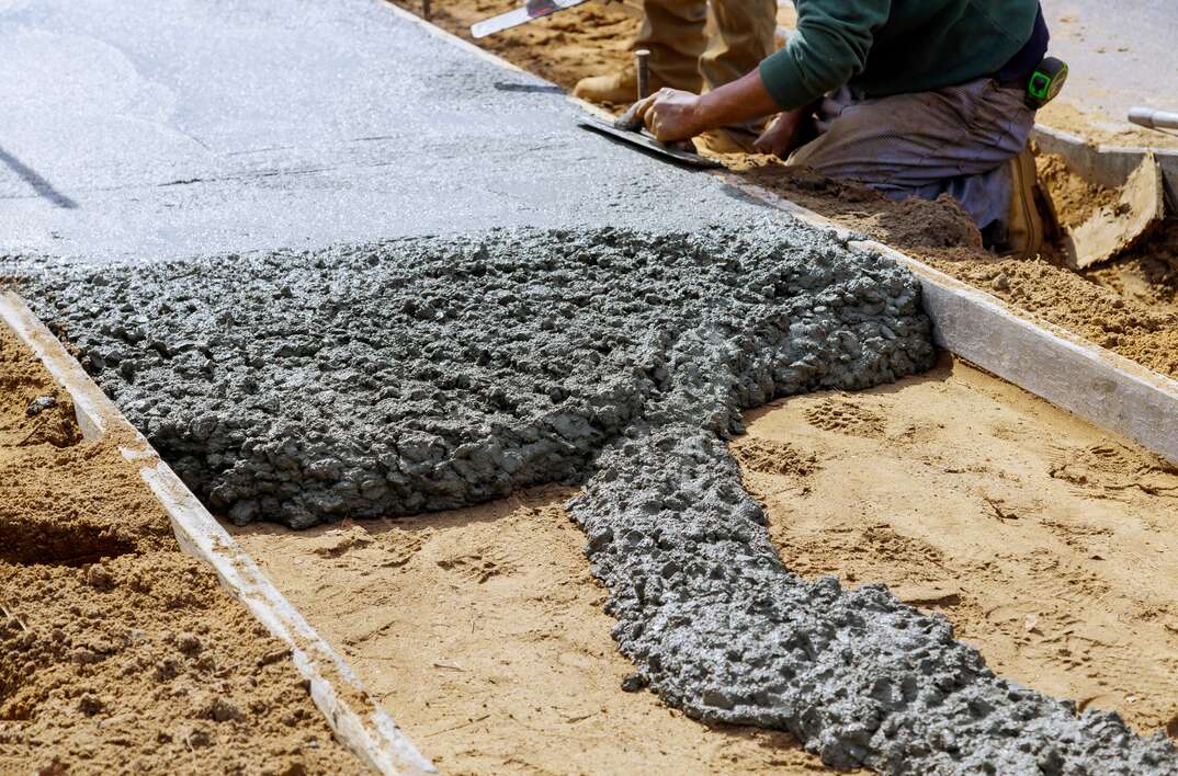 Concrete truck with pouring cement during to residential street