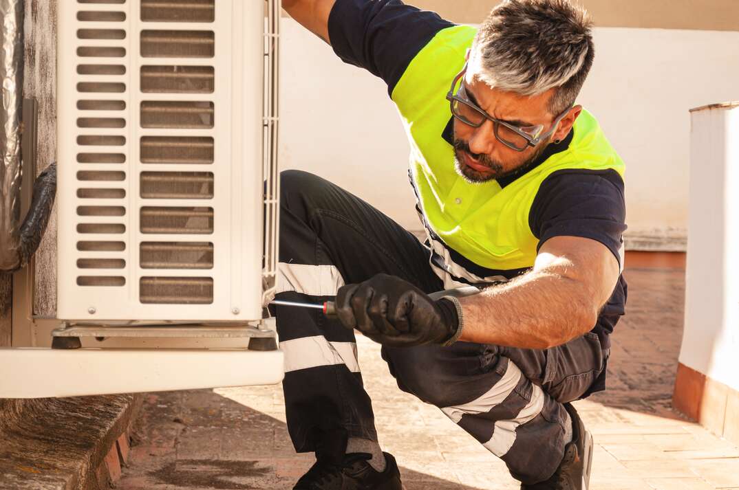 Concentrated man doing maintenance service on a fan