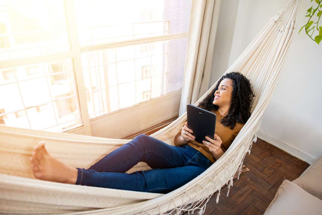 Woman relaxing in indoor hammock