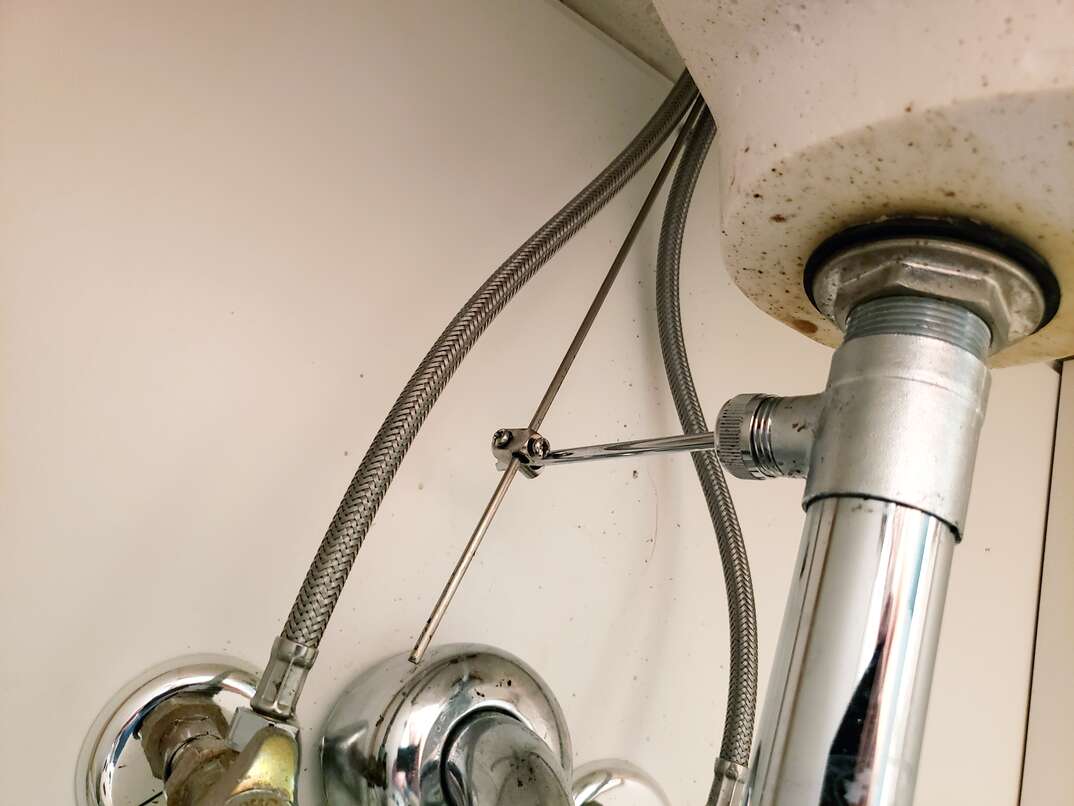 pipes and plumbing under bathroom sink
