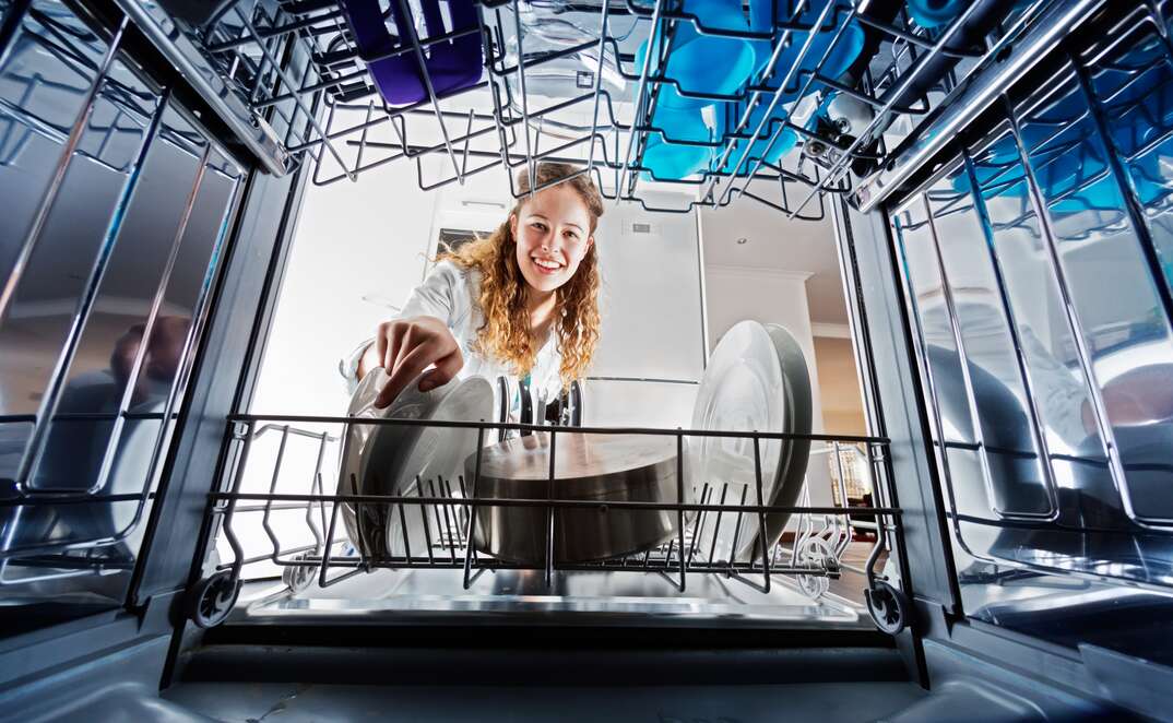 woman filling dishwasher