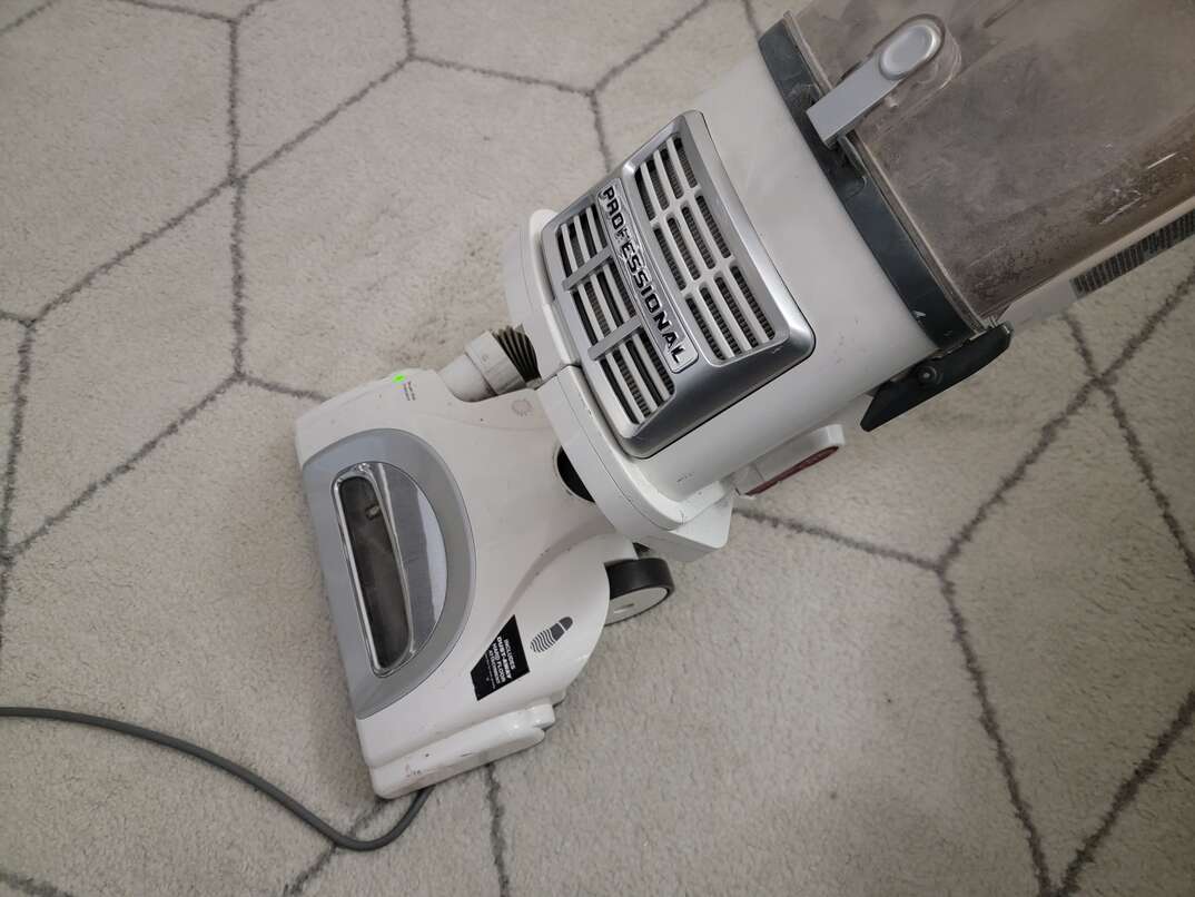 vacuuming a floor rug