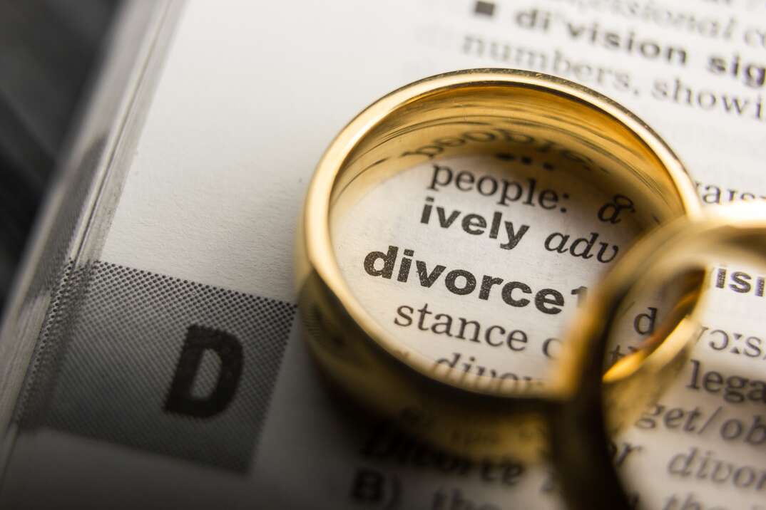 Divorce and separation concept. Two golden wedding rings. Dictionary definition.