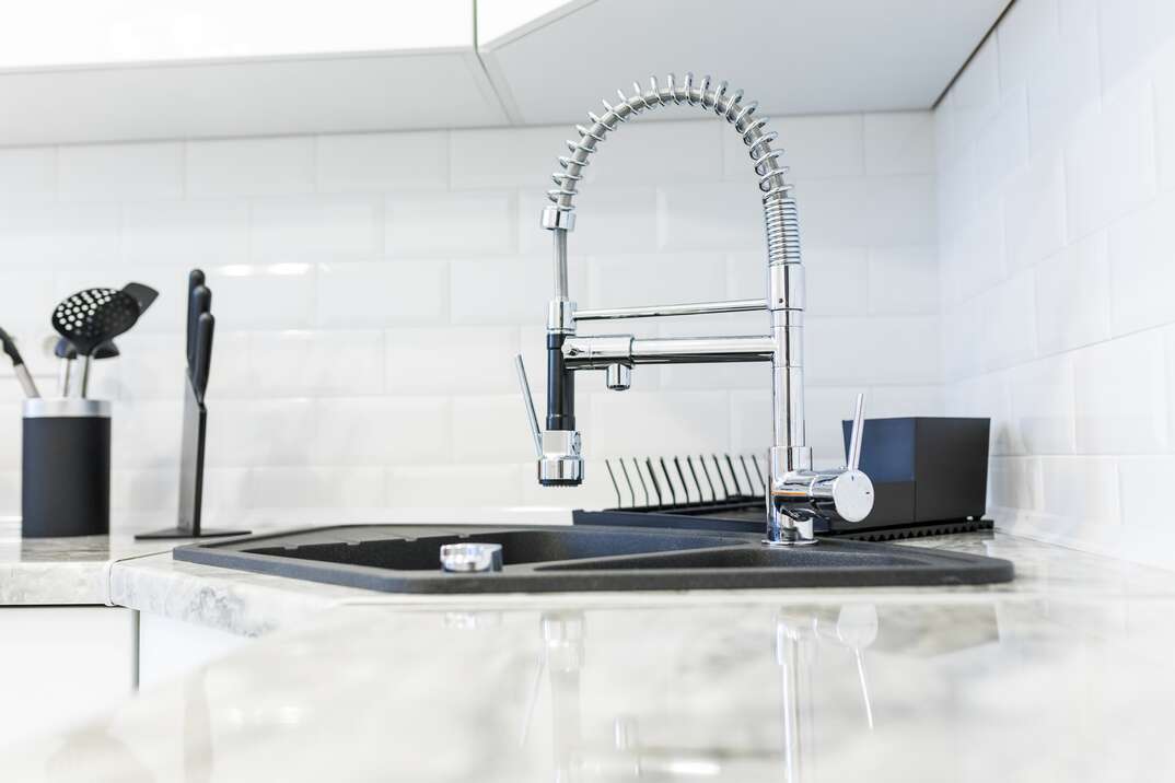 Photo of a nice, fancy sink in a mostly white kitchen