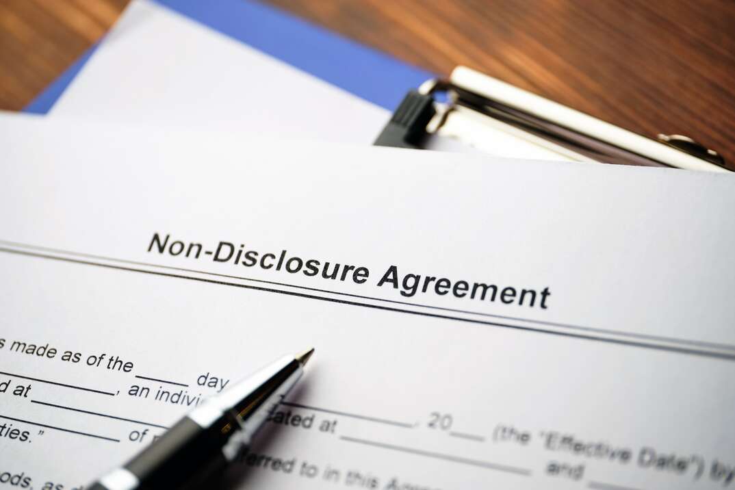 A non-disclosure agreement sits on a desk with an ink pen on top of it, non-disclosure agreement, non-disclosure, legal document, document, legal papers, paper, document, pen, ink pen, desk, desktop