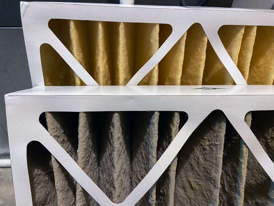 A side by side comparison of a clean HVAC furnace filter and a dirty filter 