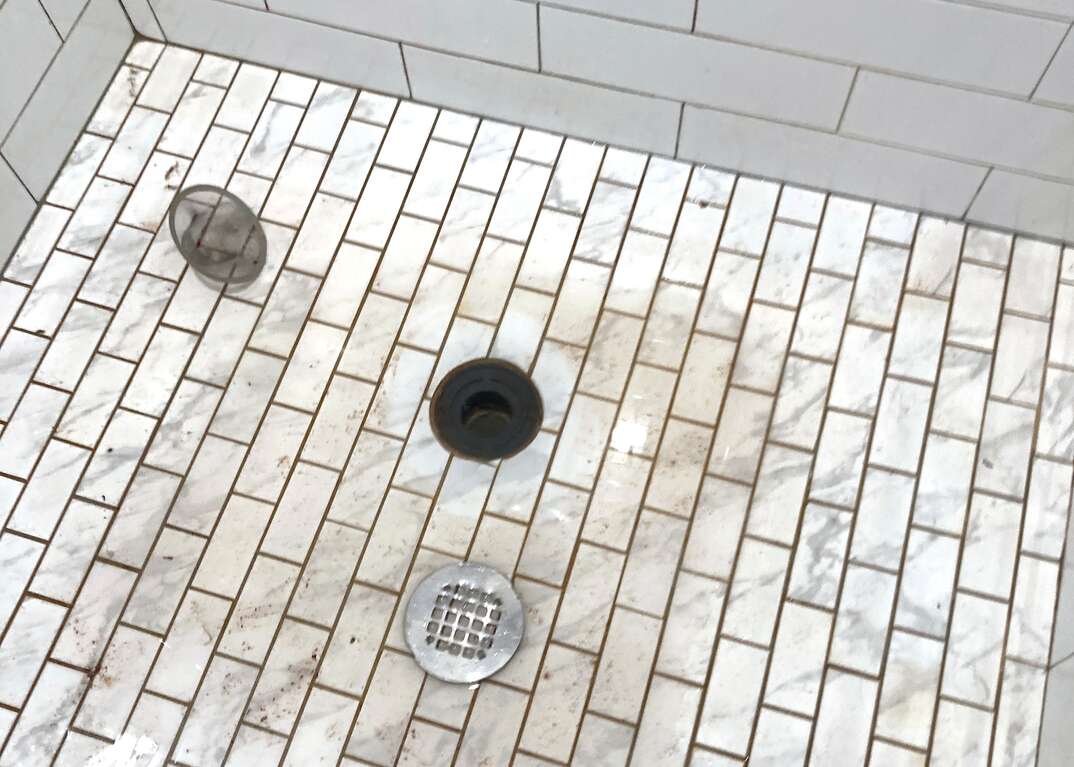 white tiled shower and drain