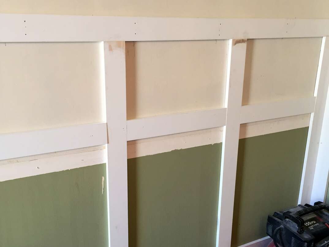 Wainscoting being attached to a wall