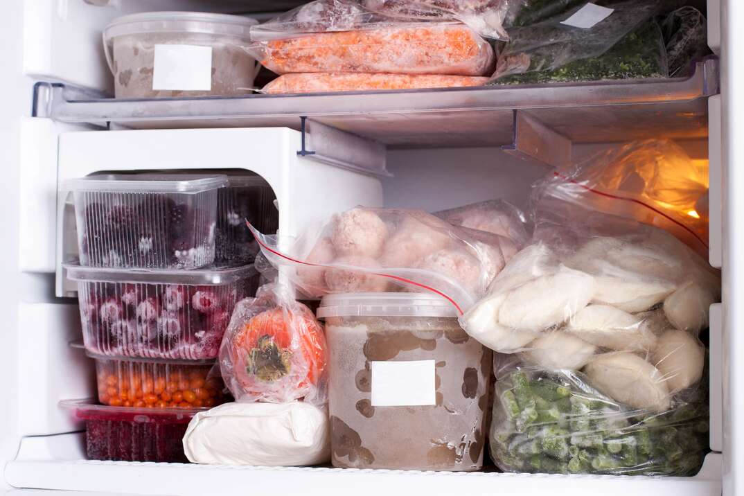 a well-stocked and organized freezer with produce and vegetables