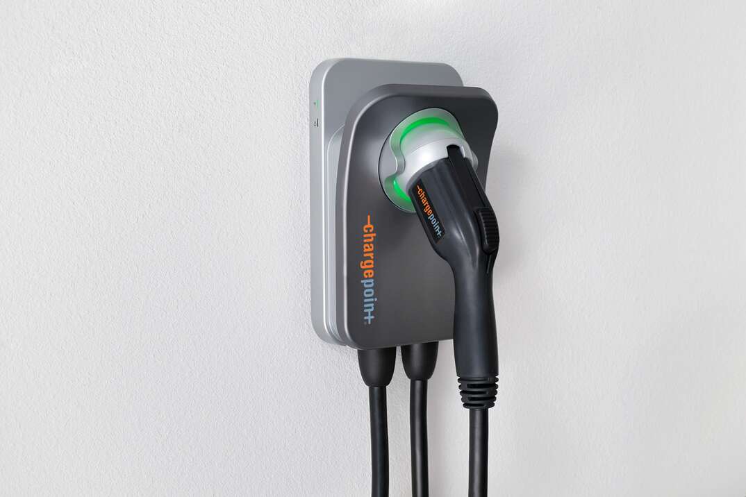 a chargepoint sph50 residential EV charger sits mounted to a while wall