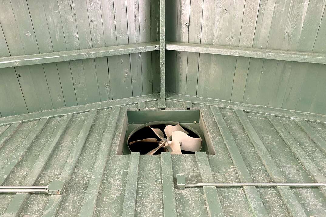 green barn roof rafters ventilation fan