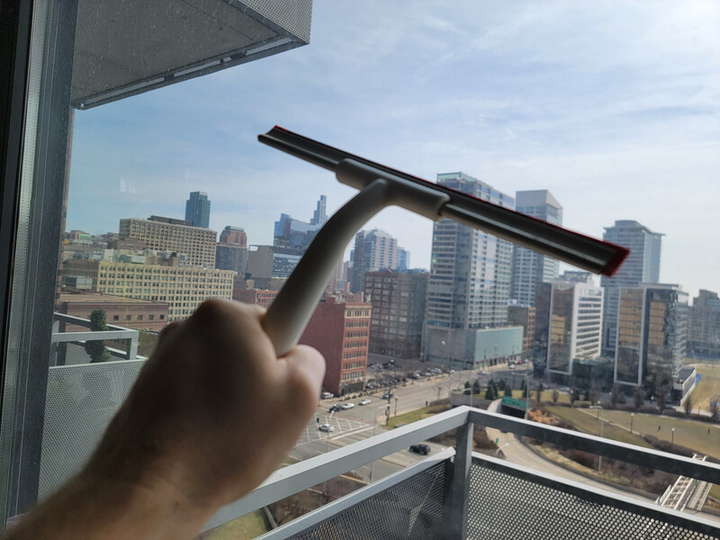 squeegeeing the glass door of a balcony