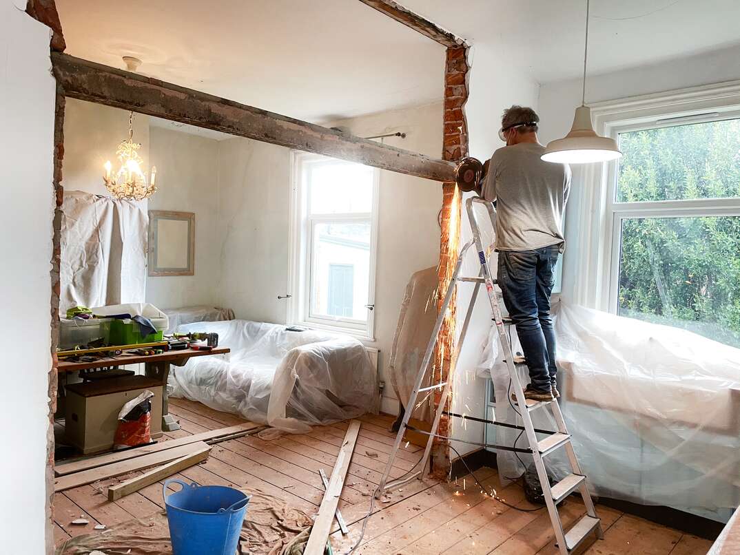 Man removing a metal beam