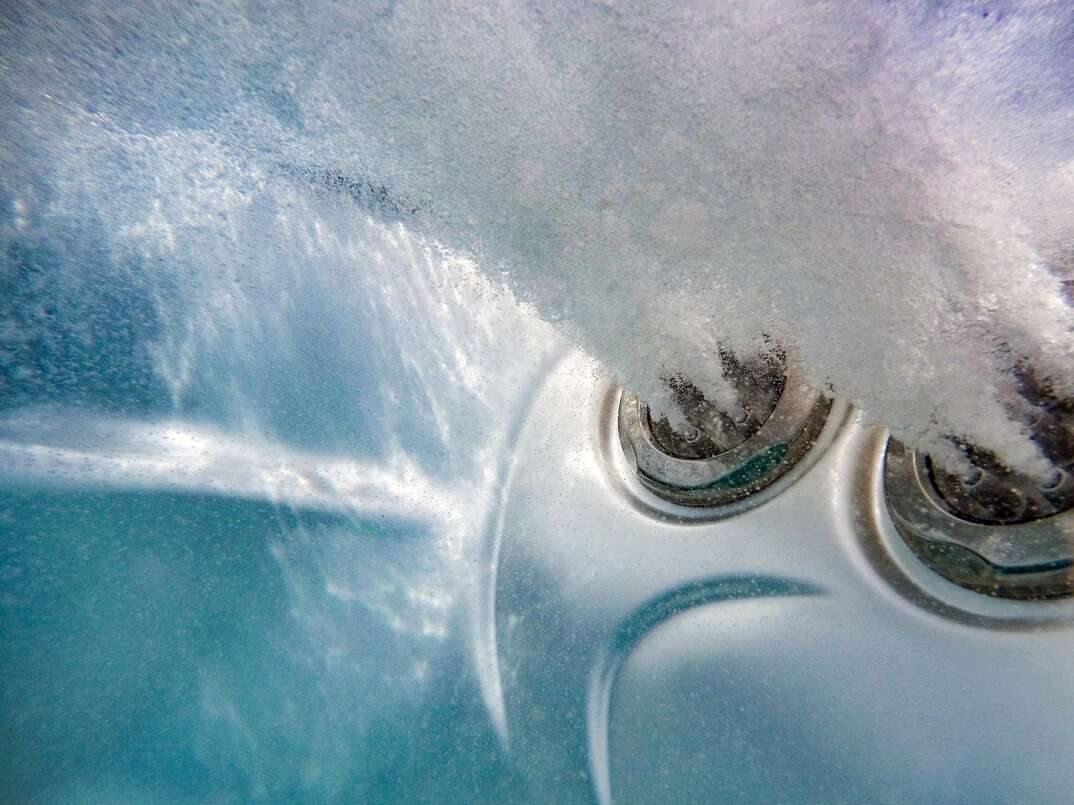 Underwater view of jets in tub spa with bubbles