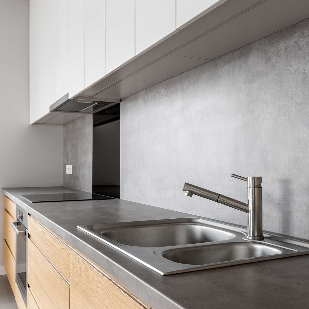 a modern kitchen showcasing a concrete counter top