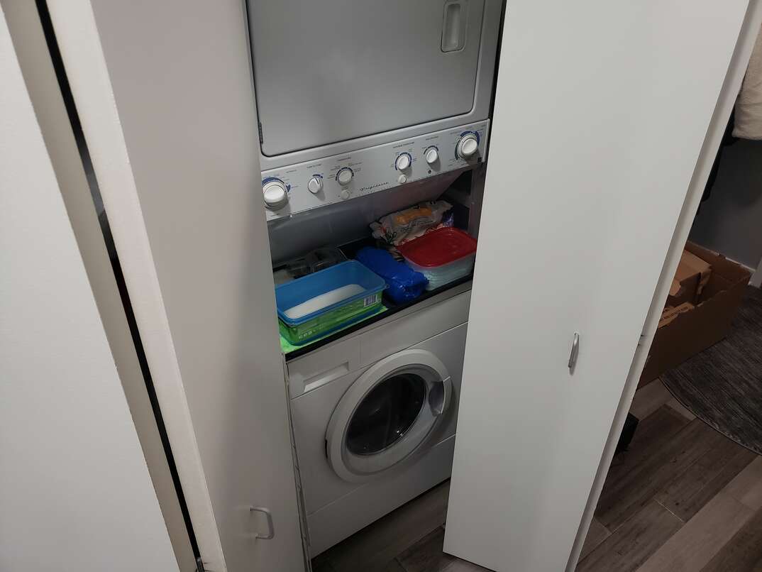 opening bifold doors to reveal laundry machines