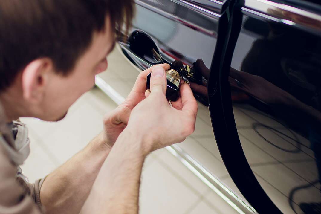 man repairing left door car locks