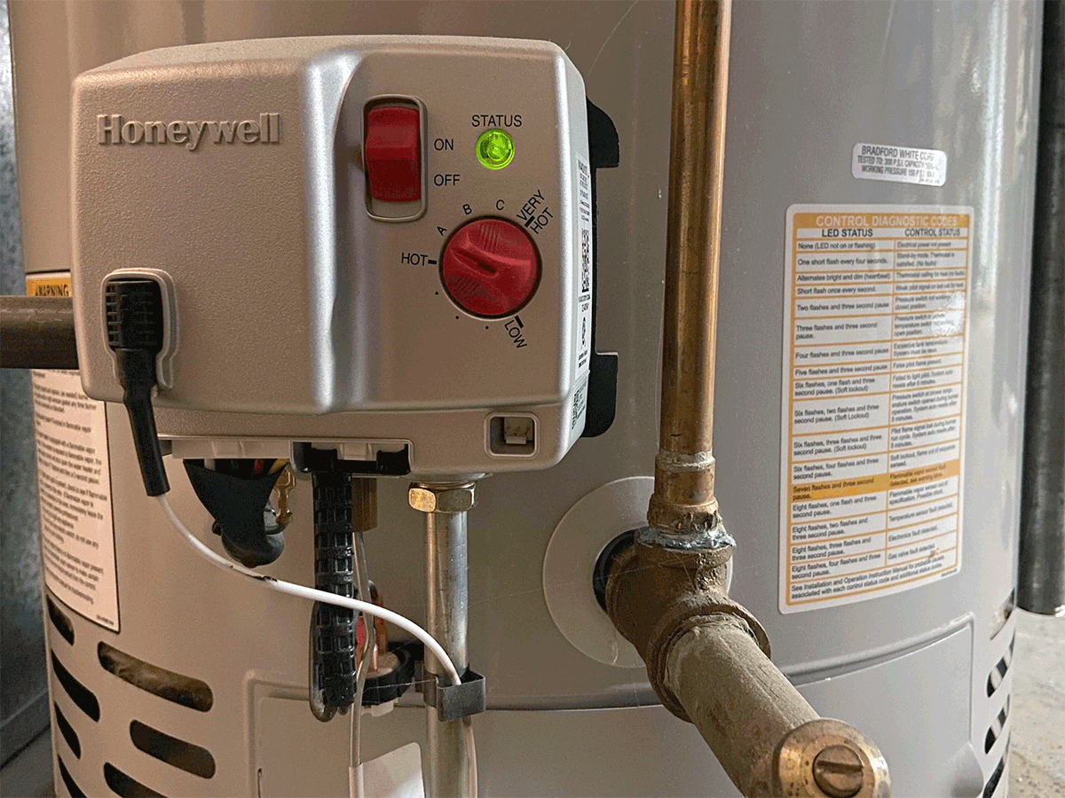 close up of a HoneyWell gas-powered high-efficiency water heater with the power switch alternating between on and off