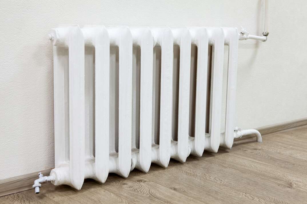 White iron radiator central heating in room