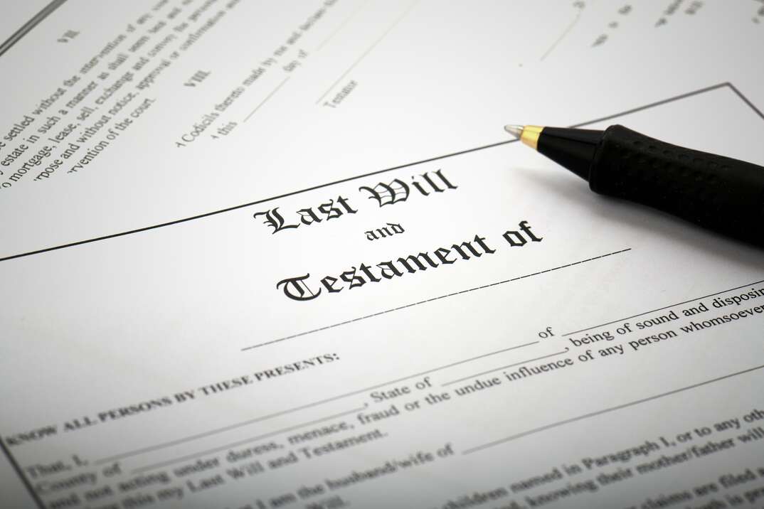 A legal document with the words Last Will and Testament at the top sits on a desk with a pen on top of it, last will and testament, will, testament, dying wishes, death, estate planning, inheritance, planning, financial planning, legal document, document, legal papers, papers