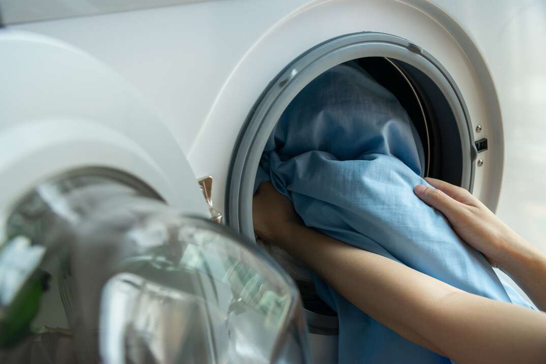 Person loading or unloading a dryer