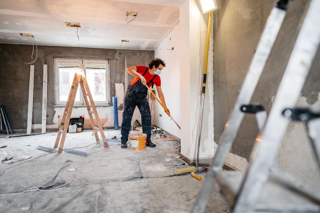 Man painting apartment walls