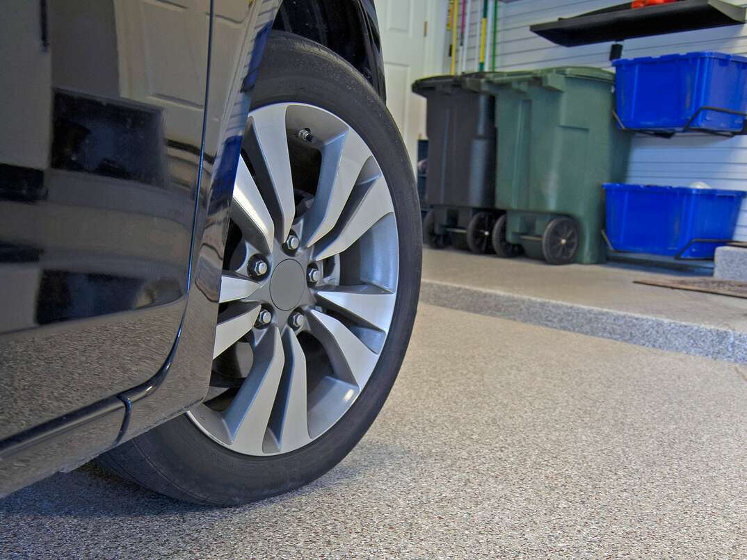 Epoxy Coating on Concrete Garage Floor with Wheel and Tire of Car visible