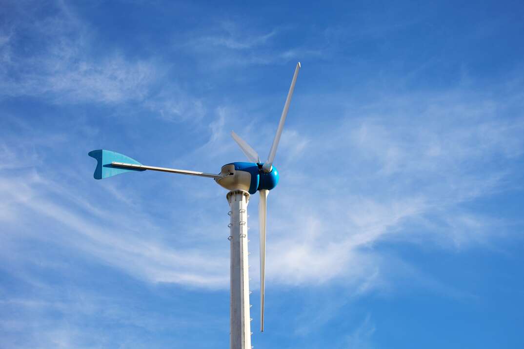 Wind Energy Turbine on Blue Sky Background