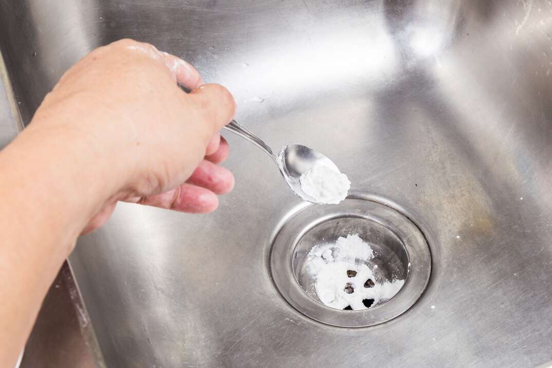 Baking soda poured to unclog drainage system at home 