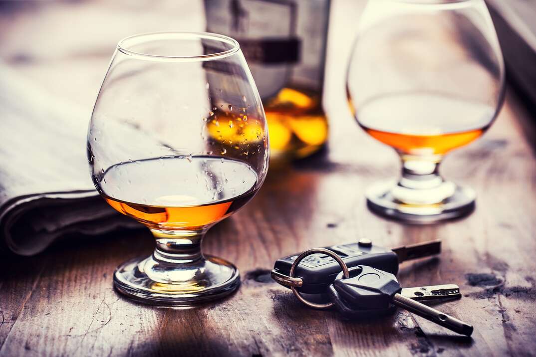 Alcoholism. Cup cognac or brandy hand man the keys to the car and irresponsible driver.