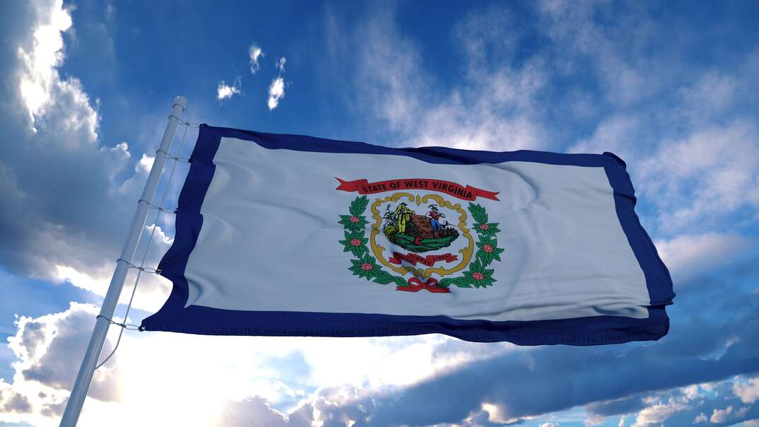 West Virginia flag on a flagpole waving in the wind