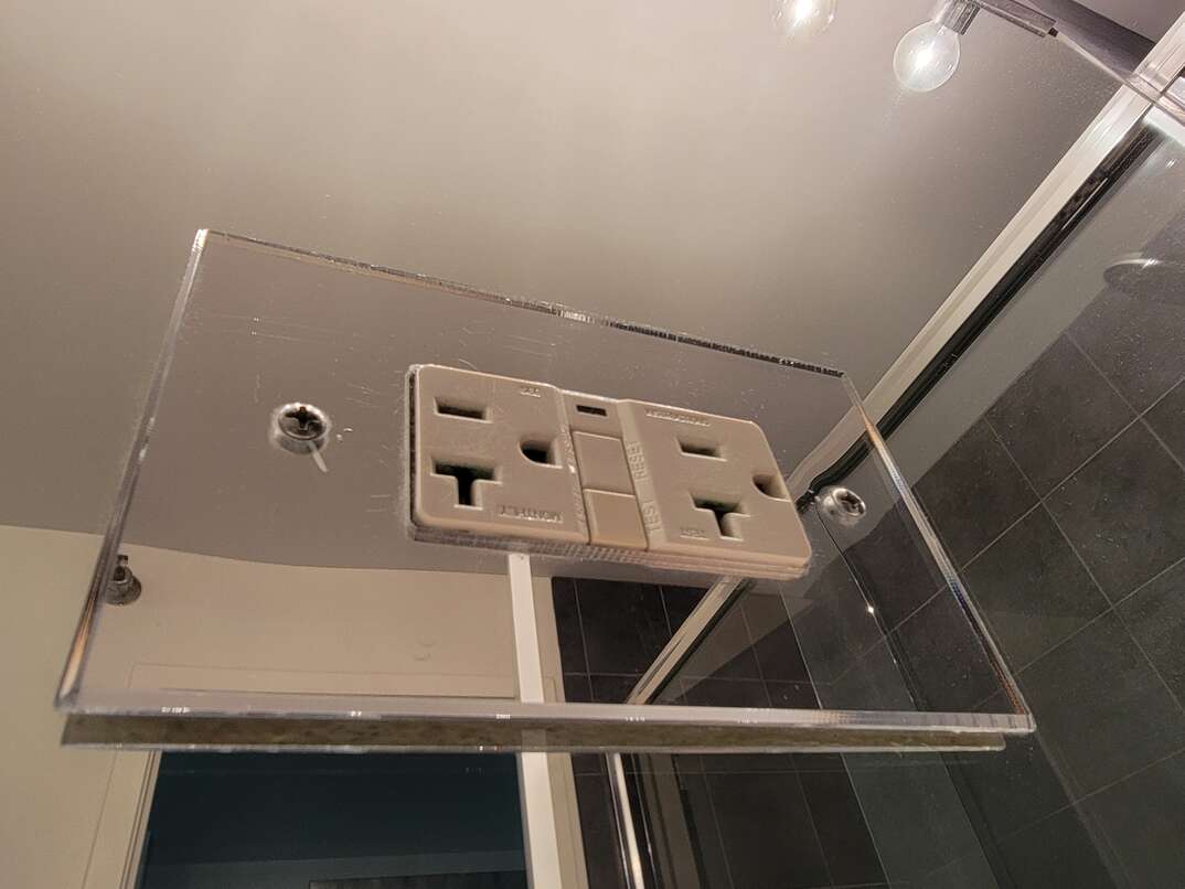 electrical outlet on glass wall