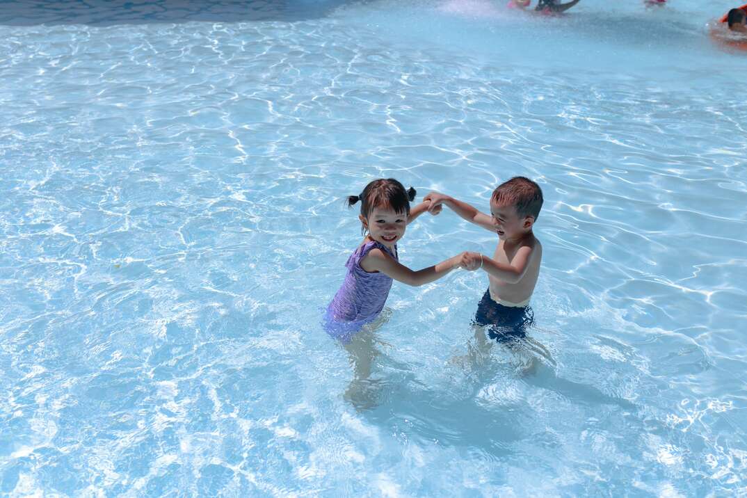 swimming pool, swimming, pool, children, kids, boy and girl, young children, having fun, blue water, clear water, sunny day, sunny, two people, holding hands